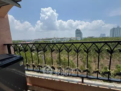 Scenic balcony view overlooking lush greenery and city skyline, perfect for relaxation and enjoying nature.