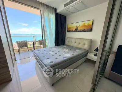 Stunning bedroom with ocean view and private balcony in modern apartment