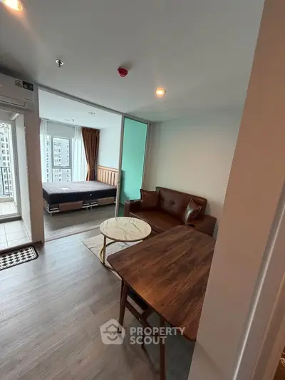 Modern studio apartment with open layout, featuring a cozy living area and bedroom with city view.