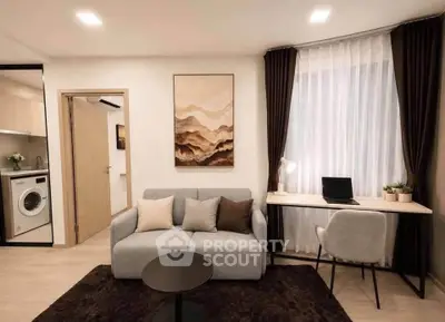 Modern living room with cozy sofa, work desk, and washing machine in stylish apartment.