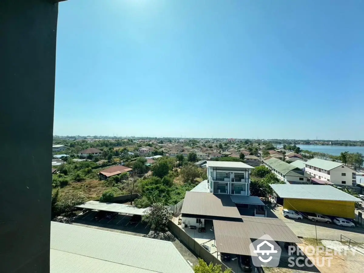 Stunning panoramic view from high-rise building overlooking suburban landscape and distant horizon.