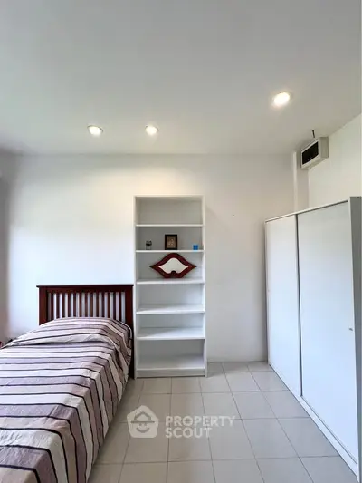 Bright bedroom with modern furniture and ample storage space