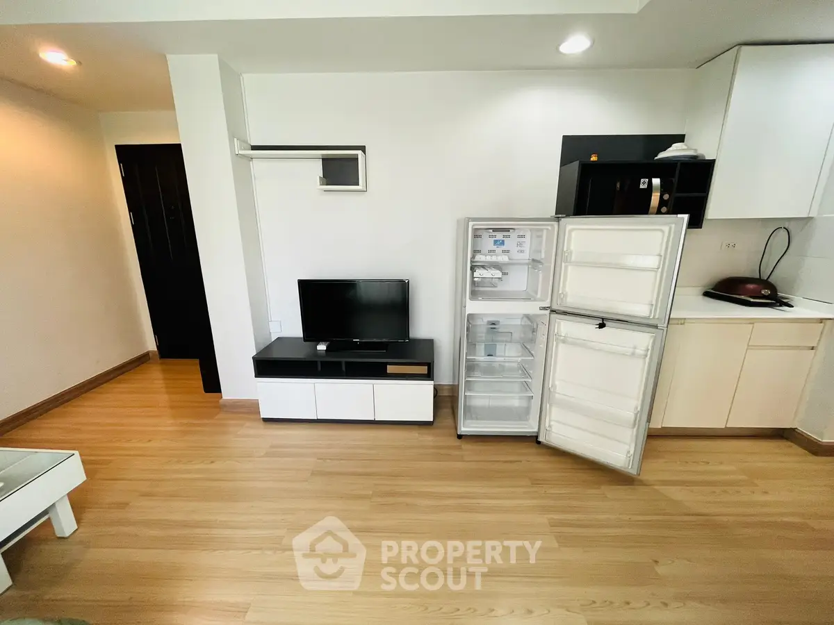 Modern living space with open fridge and sleek furniture