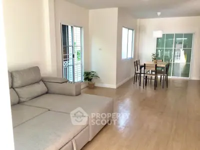 Spacious living and dining area with modern decor and natural light