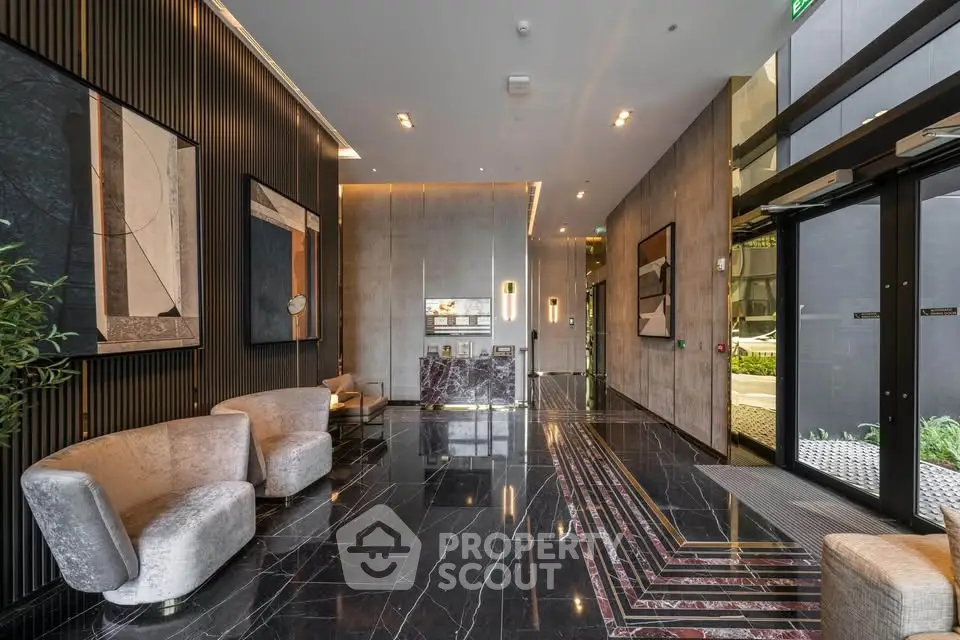 Luxurious modern building entrance with elegant marble flooring and stylish seating area.