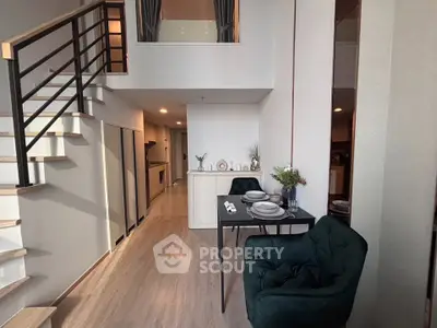 Modern duplex apartment with stylish dining area and staircase