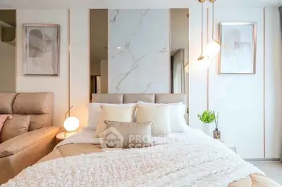 Luxurious bedroom with elegant decor and modern lighting, featuring a plush bed and stylish wall art.