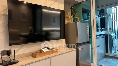 Modern living room with sleek TV and stylish kitchen appliances