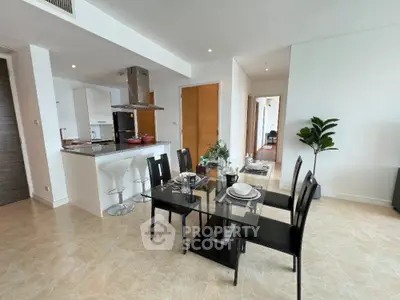 Modern open-plan kitchen and dining area with sleek design and natural light