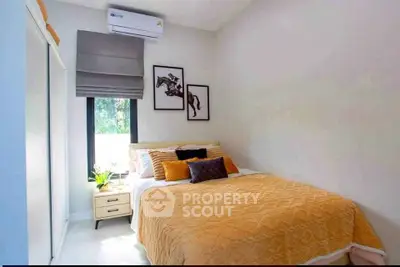 Cozy bedroom with stylish decor and natural light, featuring modern artwork and a comfortable bed.