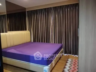 Modern bedroom with stylish curtains and comfortable bed in cozy apartment
