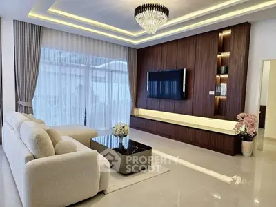 Luxurious modern living room with elegant chandelier and sleek TV setup