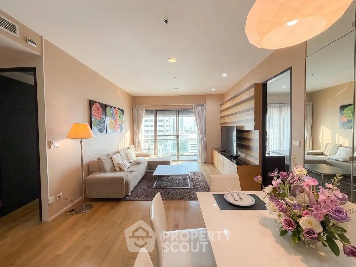 Spacious modern living room with elegant decor and city view balcony