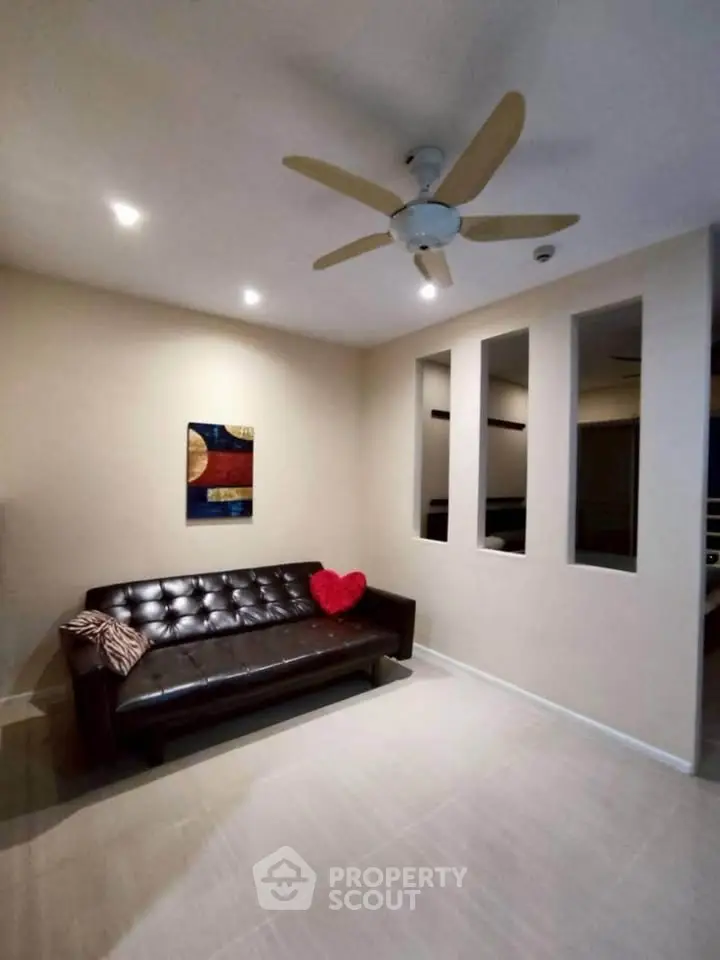 Cozy living room with modern decor and ceiling fan