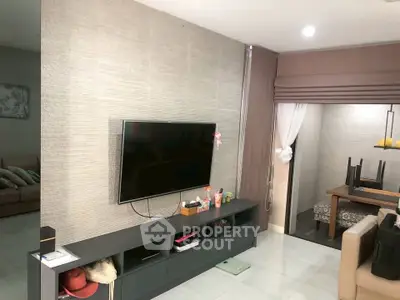 Modern living room with wall-mounted TV and stylish decor