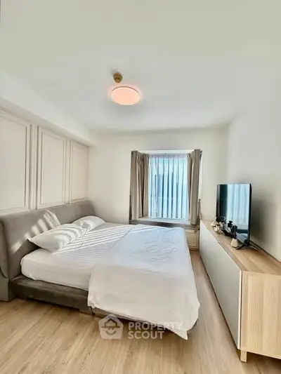 Bright and cozy bedroom with modern furnishings and natural light