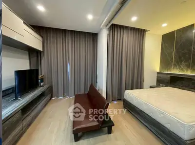 Modern bedroom with sleek design, featuring a comfortable bed and stylish sofa, perfect for relaxation.