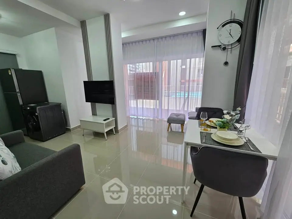 Modern living room with sleek furniture and large windows offering ample natural light.