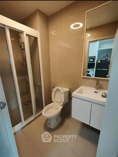 Modern bathroom with sleek shower and contemporary fixtures in a stylish apartment.