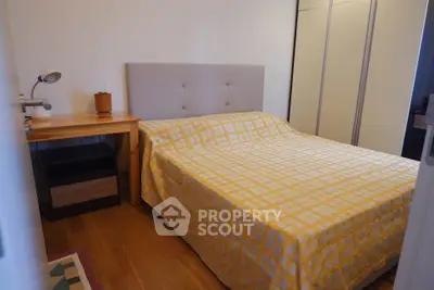 Cozy bedroom with wooden flooring and modern furniture