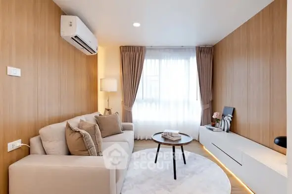 Modern living room with cozy sofa, stylish decor, and natural light