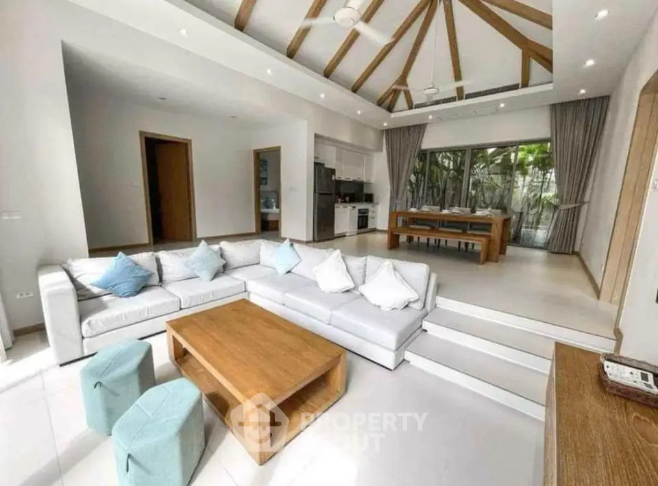 Spacious modern living room with open kitchen and stylish wooden accents
