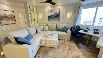 Elegant living room with modern decor, cozy sectional sofa, and dining area with city view.