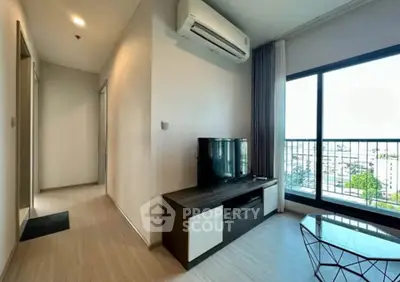 Modern living room with air conditioning and city view from large window.