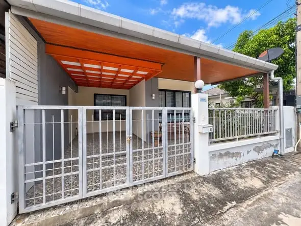 Charming single-story home with covered carport and gated entrance, perfect for cozy living.