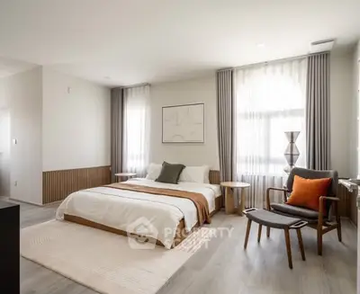 Spacious modern bedroom with elegant decor and natural light