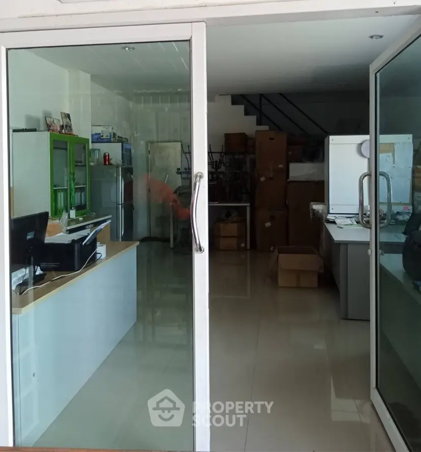 Spacious office space with glass doors and modern interior design