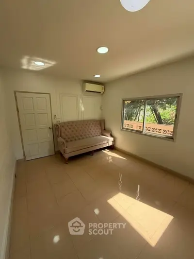 Bright living room with elegant sofa and large window view