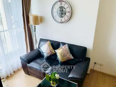 Chic living room with leather sofa, stylish clock, and elegant decor in modern apartment.