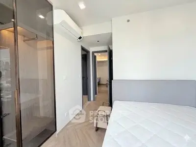 Modern bedroom with sleek design and air conditioning in a contemporary apartment.