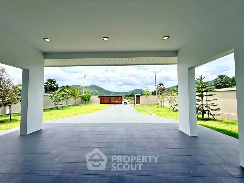 Spacious driveway with scenic mountain views and lush greenery, perfect for luxury living.