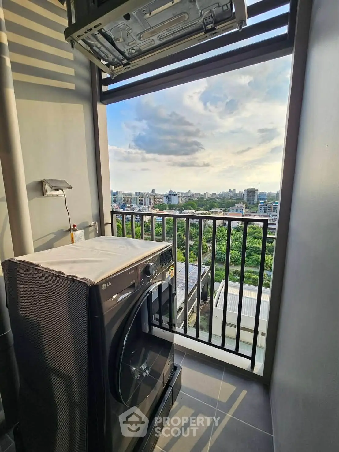 High-rise apartment balcony with washing machine and stunning city view