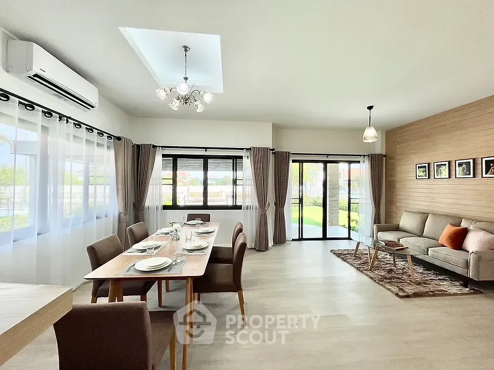 Spacious modern living room with dining area and large windows