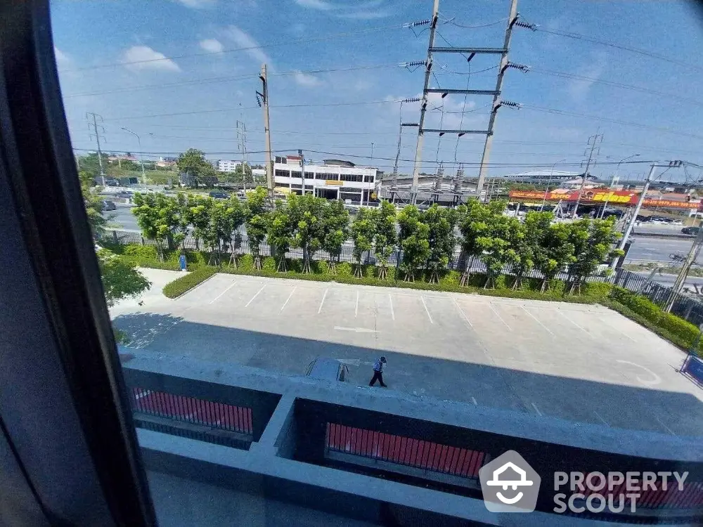 Spacious parking lot view from building window with clear blue sky