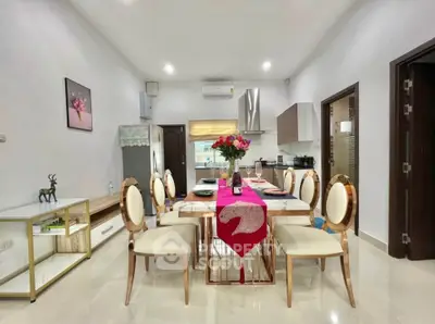 Elegant dining area with modern decor and open kitchen layout, perfect for entertaining guests.