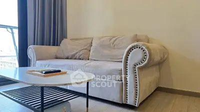Stylish living room with elegant beige sofa and modern coffee table, perfect for relaxation.