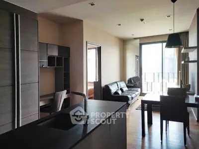 Modern open-layout living room with sleek kitchen and city view balcony.
