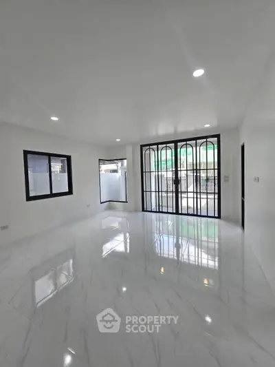 Spacious modern living room with marble flooring and large windows