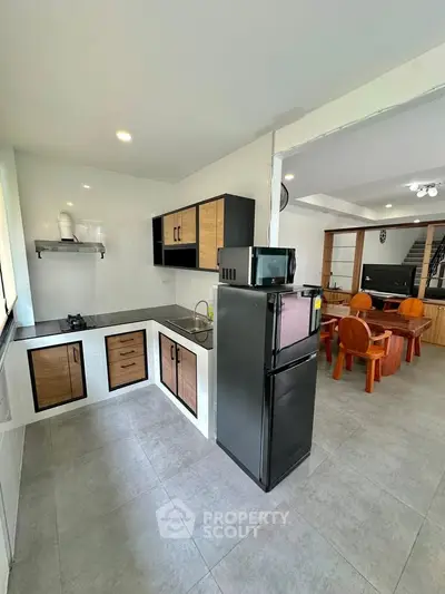 Modern kitchen with sleek cabinets and dining area in open layout
