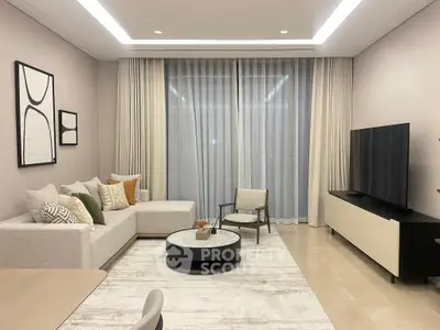 Elegant modern living room with stylish decor and large TV, perfect for relaxation and entertainment.