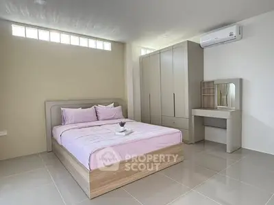 Spacious modern bedroom with sleek furniture and natural light