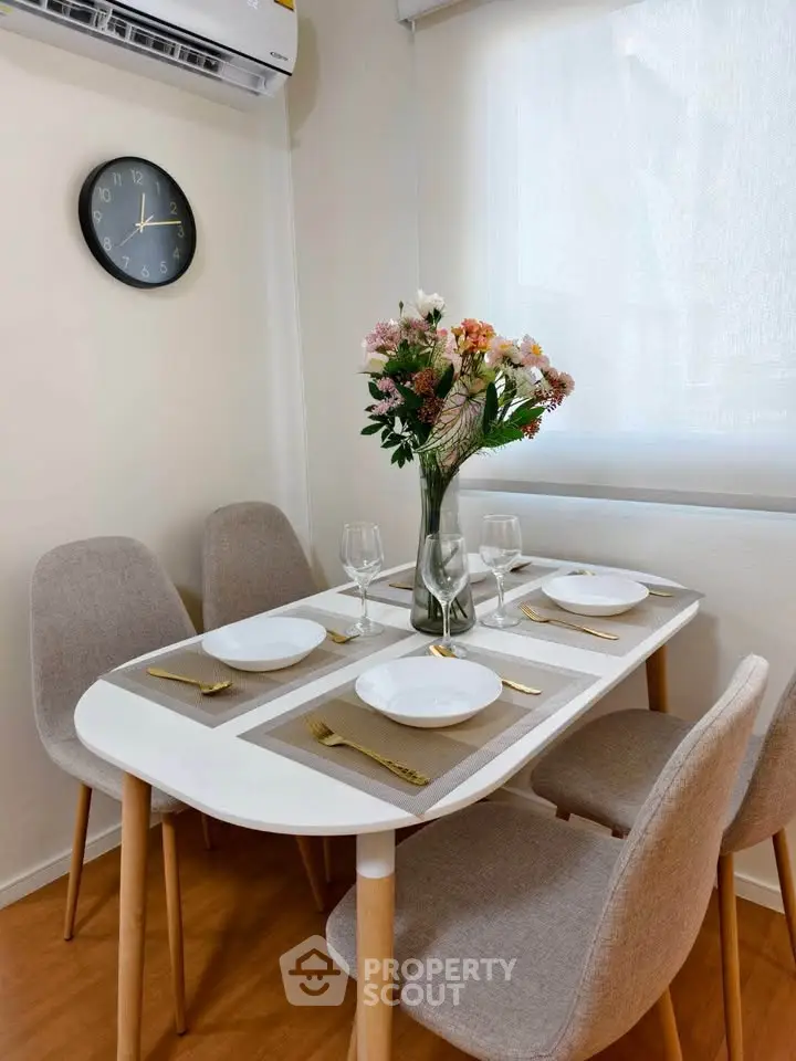 Charming dining area with elegant table setting and floral centerpiece, perfect for intimate gatherings.