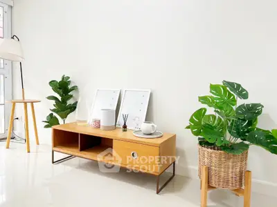 Stylish modern living room with wooden furniture and lush green plants