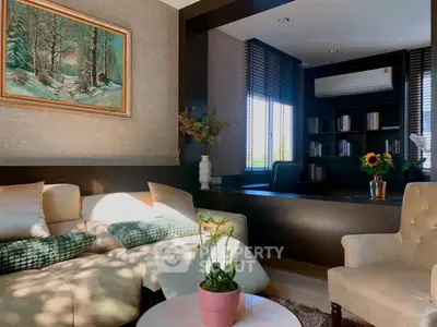 Elegant living room with cozy seating and stylish decor, perfect for relaxation and entertainment.