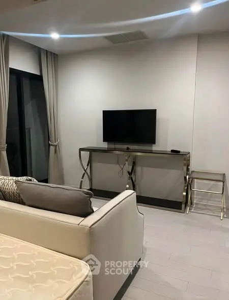 Modern living room with sleek furniture and wall-mounted TV, perfect for contemporary urban living.