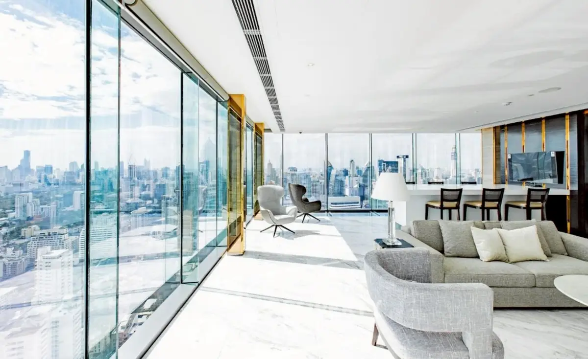 Luxurious high-rise living room with panoramic city views and modern furnishings.